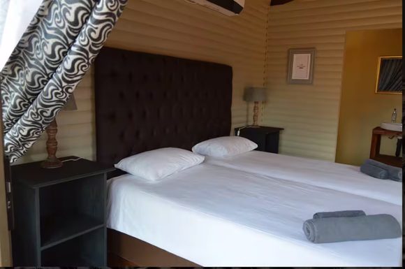 Standard Cabin Interior - Twin beds with air conditioning and private bathroom at Maseri Cabins